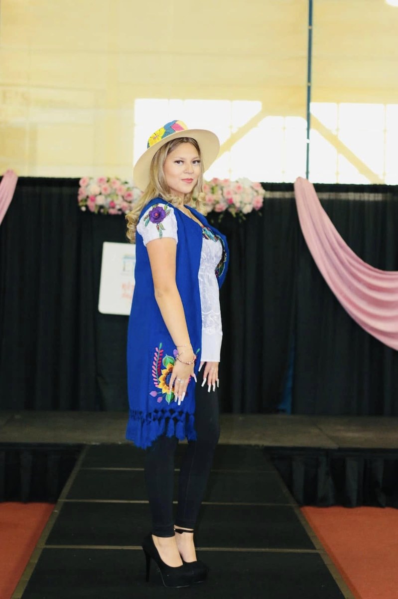 Amynta Baten traje azul bordado sombrero
